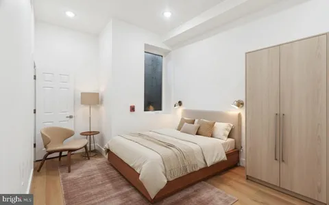 a bedroom with bed and a window