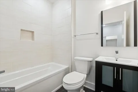 a bathroom with a toilet a sink and a bathtub