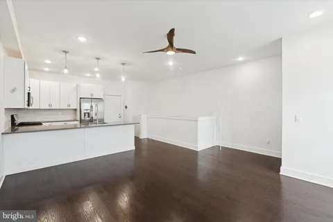 a view of kitchen with wooden floor and window