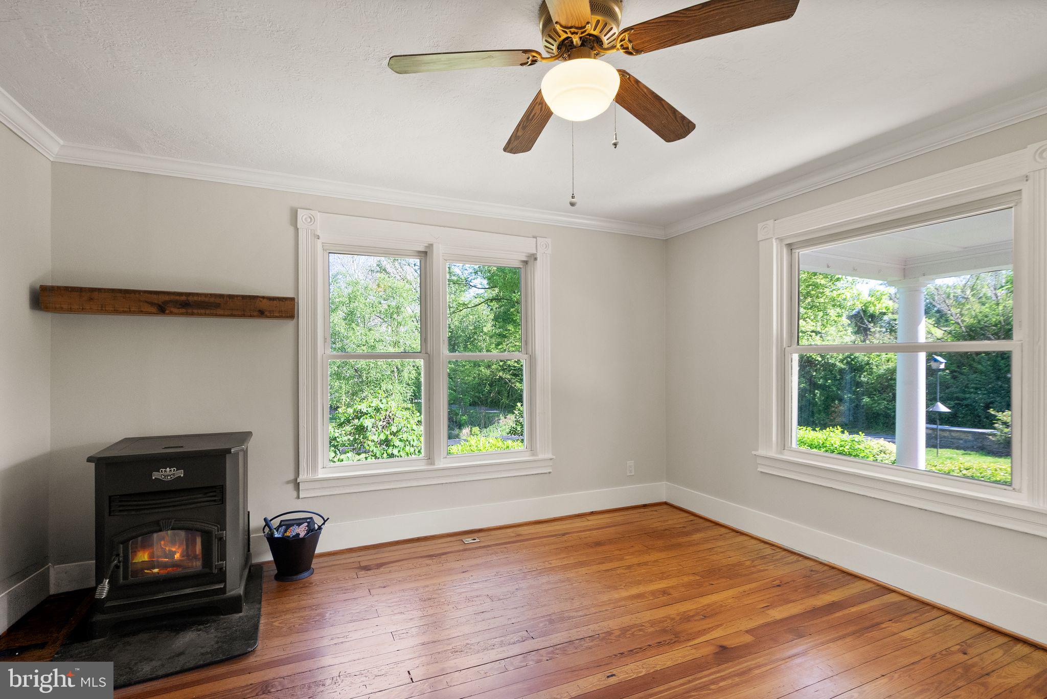37151 Branchriver Road Purcellville, VA 20132 - Photo 13 of 63 a view of an empty room with wooden floor fireplace and a window