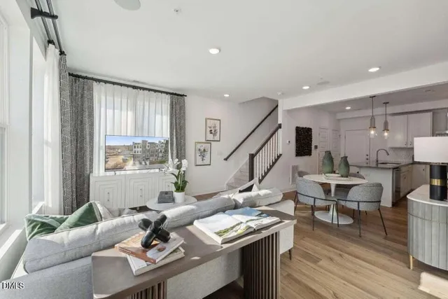 a living room with furniture and floor to ceiling windows