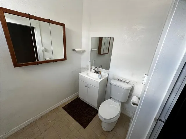 a white toilet sitting next to a bathroom sink