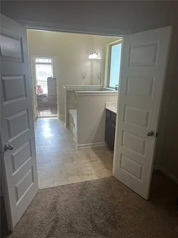 a view of hallway with stairs and wooden floor