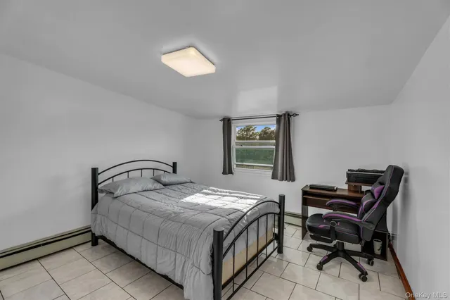 a bedroom with a bed and a desk