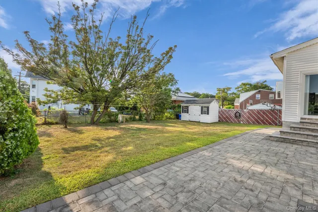 a front view of a house with a yard and trees