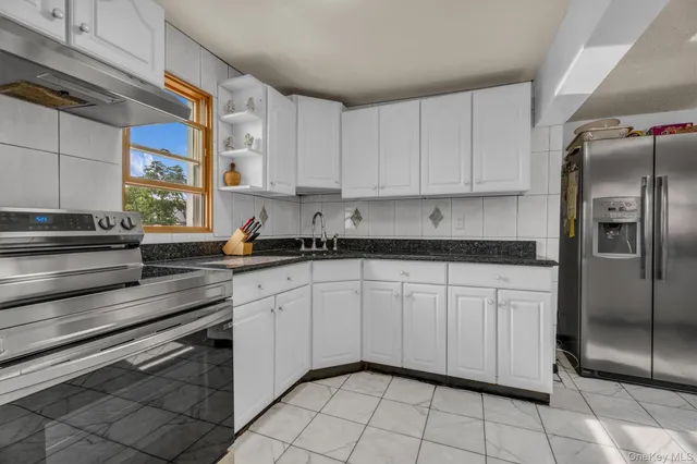 a kitchen with cabinets and stainless steel appliances