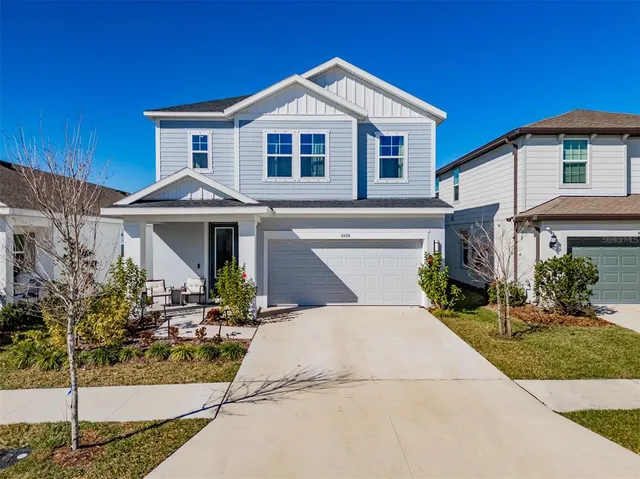 a kitchen with stainless steel appliances kitchen island granite countertop a sink a stove a dining table and chairs