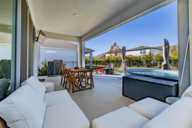 a swimming pool with outdoor seating and garden