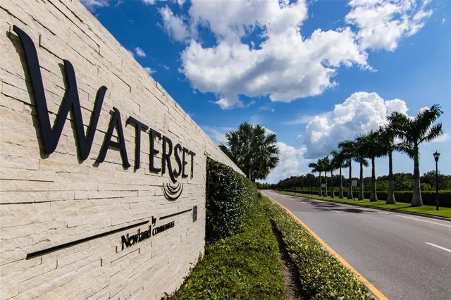 a view of a swimming pool with lawn chairs