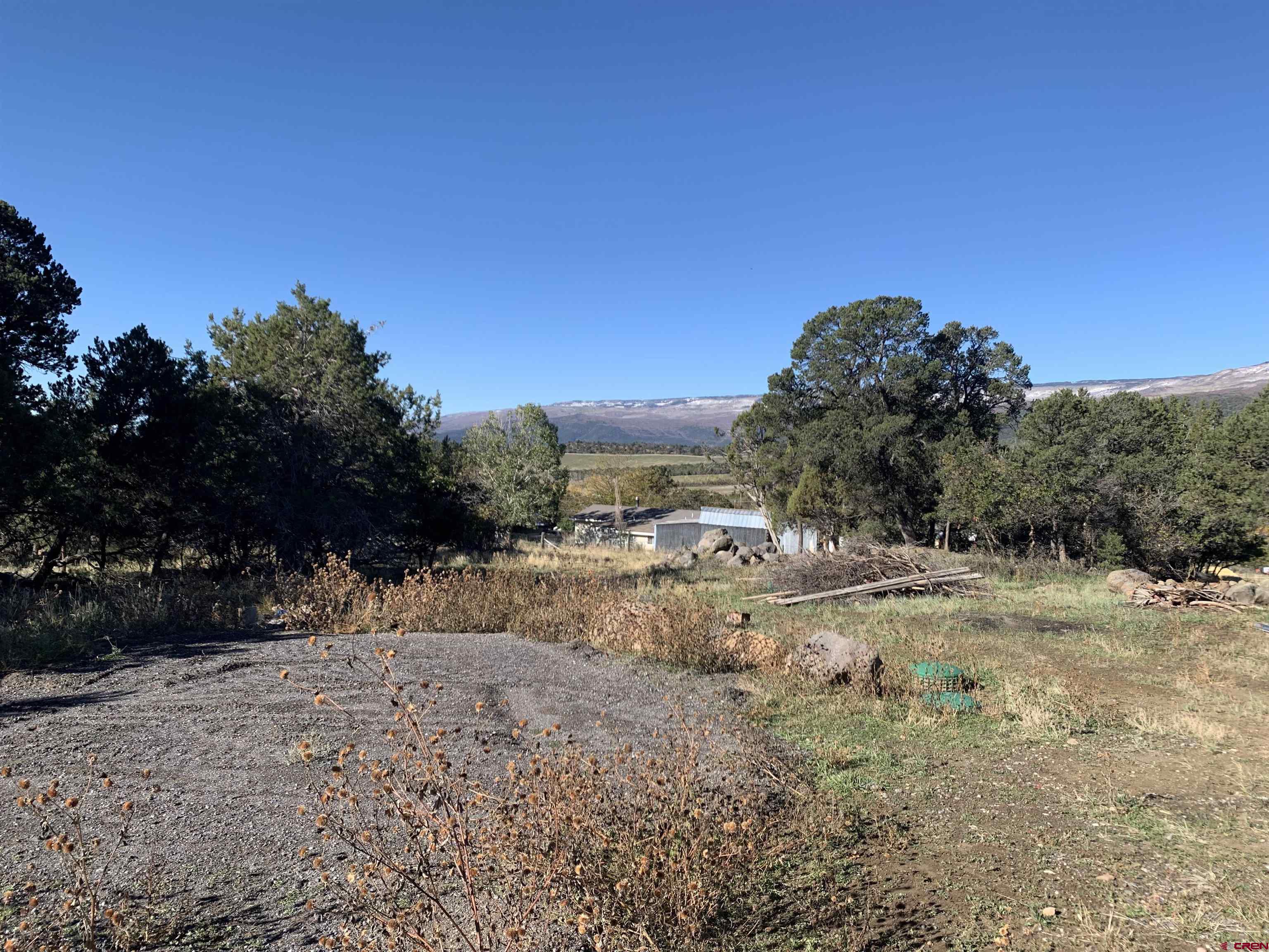 23202 Ute Trail Road Cedaredge, CO 81413 - Photo 12 of 14 a view of dirt road and a building