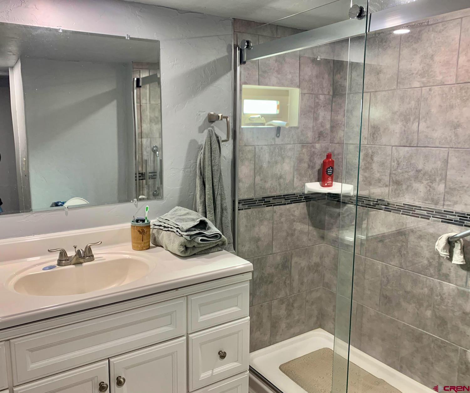 23202 Ute Trail Road Cedaredge, CO 81413 - Photo 3 of 14 a bathroom with a sink and a shower