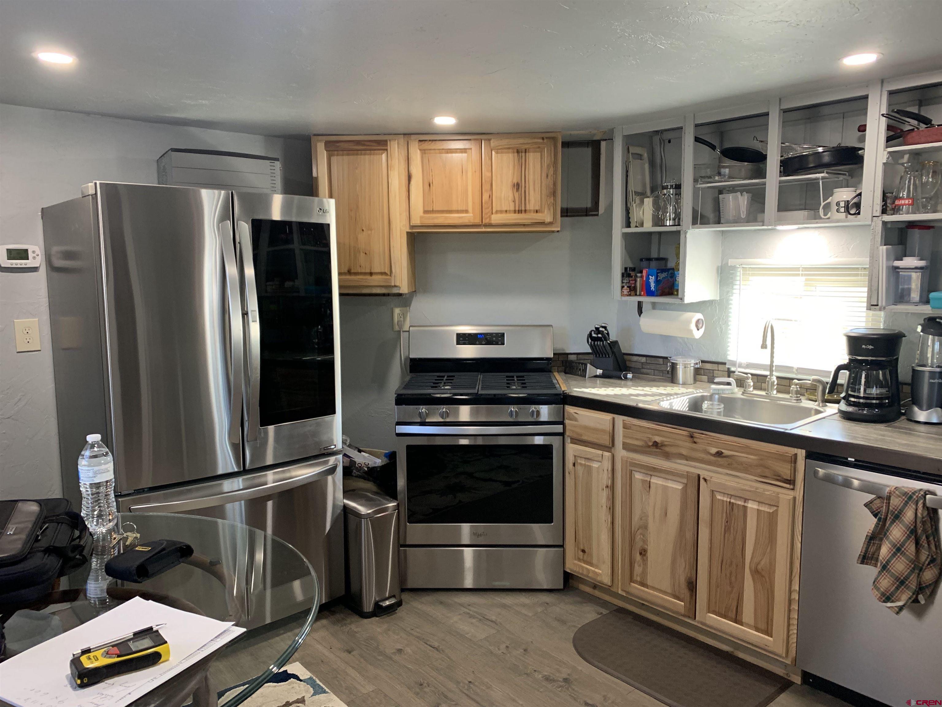 23202 Ute Trail Road Cedaredge, CO 81413 - Photo 4 of 14 a kitchen with granite countertop a refrigerator stove and sink