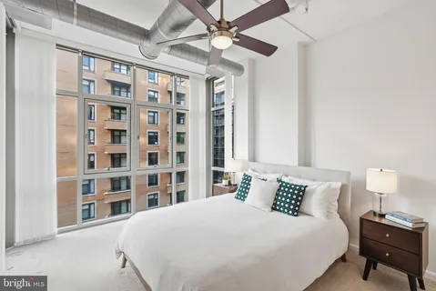 a bedroom with a large bed and a chandelier