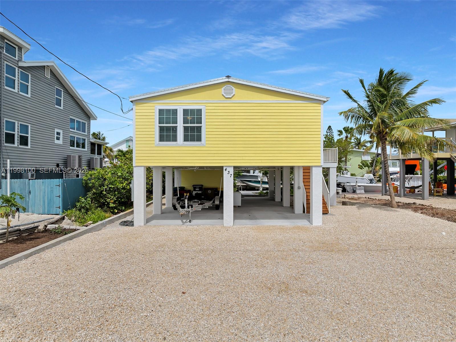 437 Pirates Road Summerland Key, FL 33042 - Photo 3 of 39 a view of a house with backyard and sitting area