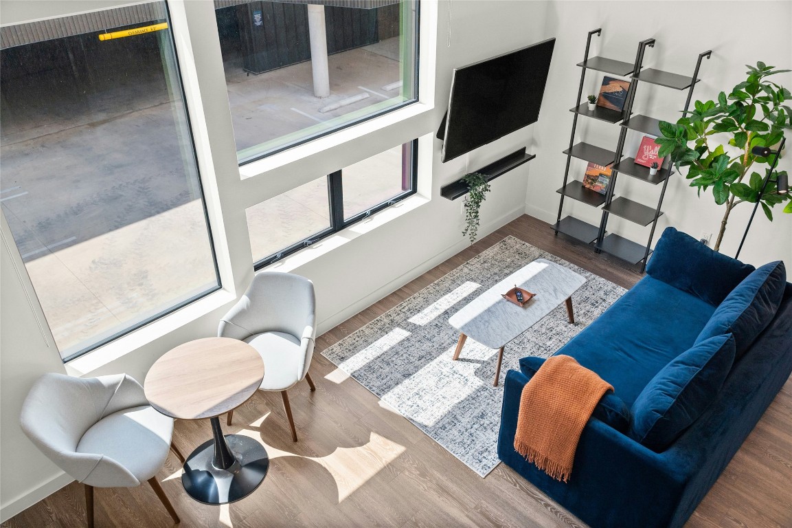 49 Navasota Street, Unit 214 Austin, TX 78702 - Photo 16 of 37 a living room with furniture and a flat screen tv