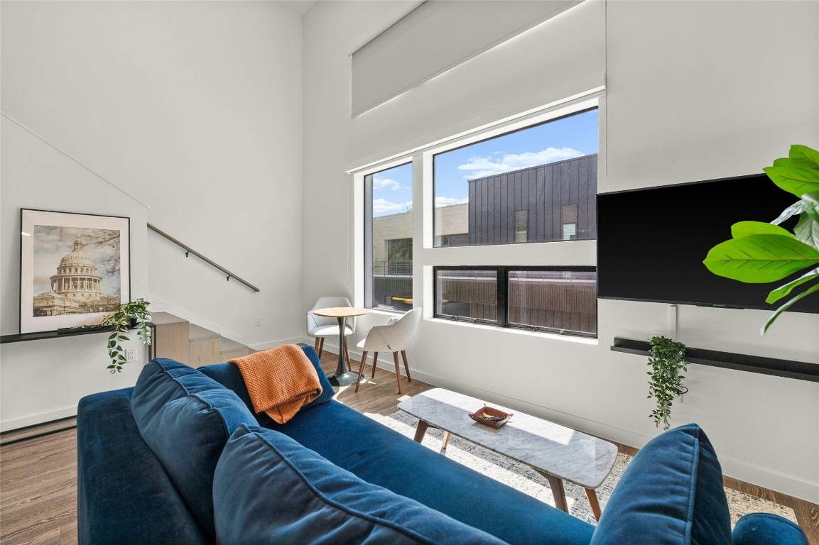 49 Navasota Street, Unit 214 Austin, TX 78702 - Photo 17 of 37 a living room with furniture and wooden floor