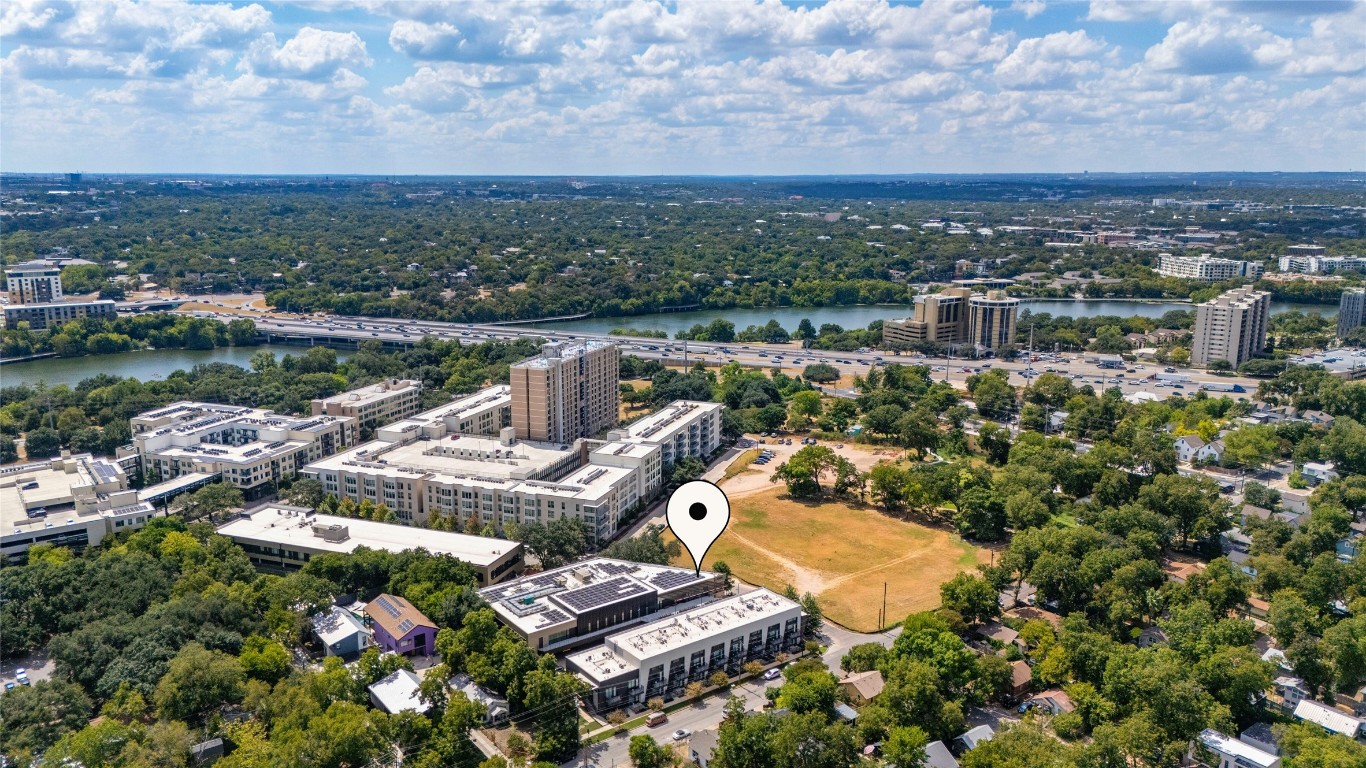 49 Navasota Street, Unit 214 Austin, TX 78702 - Photo 2 of 37 an aerial view of a house with a floor to ceiling window and lake view