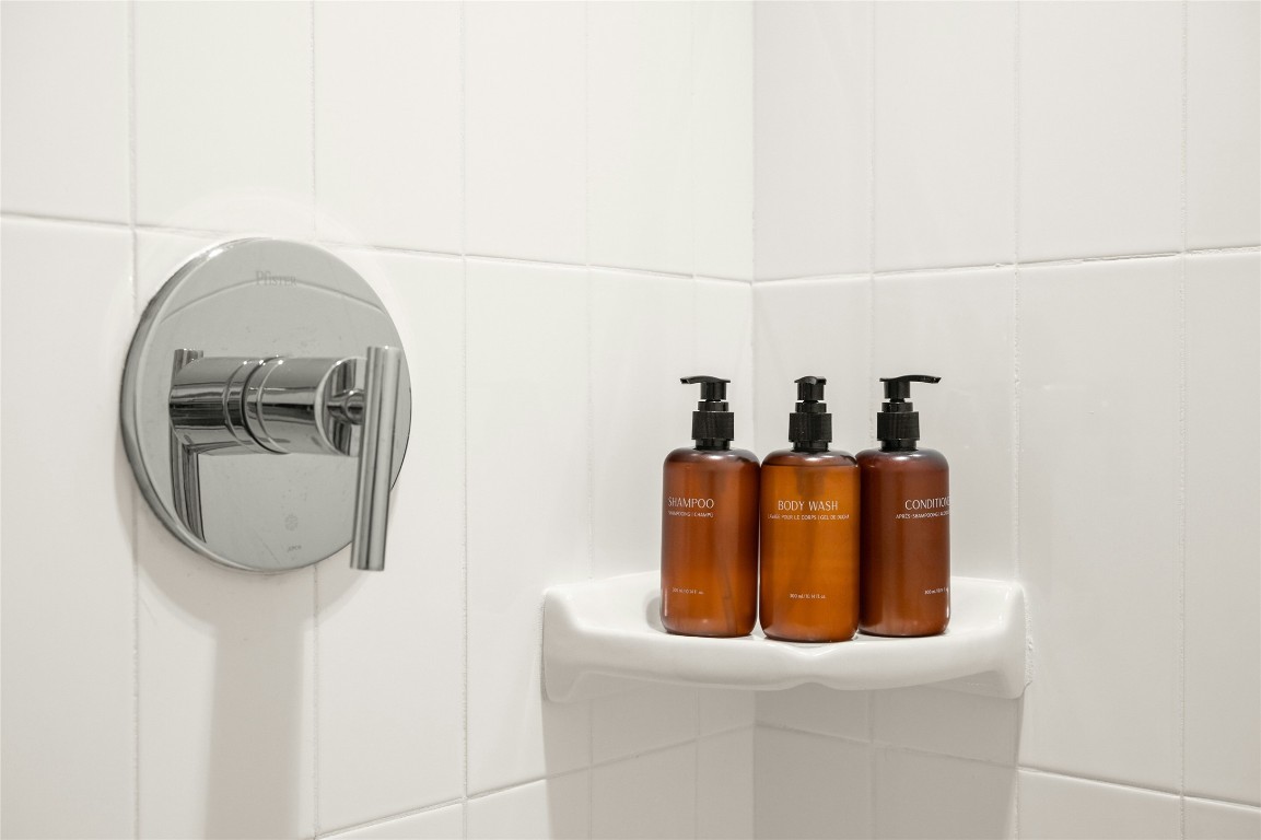 49 Navasota Street, Unit 214 Austin, TX 78702 - Photo 32 of 37 a bathroom with a sink and mirror