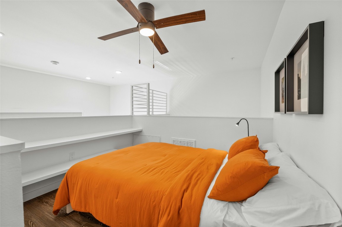 49 Navasota Street, Unit 214 Austin, TX 78702 - Photo 35 of 37 a bedroom with a bed and a chandelier