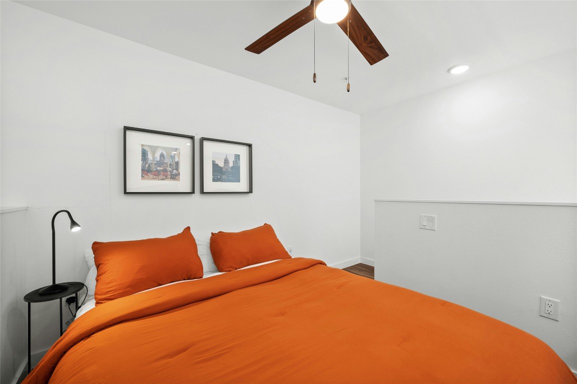 49 Navasota Street, Unit 214 Austin, TX 78702 - Photo 36 of 37 a bedroom with bed and painting on the wall