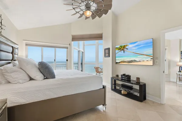 a bedroom with a bed and a painting on the wall