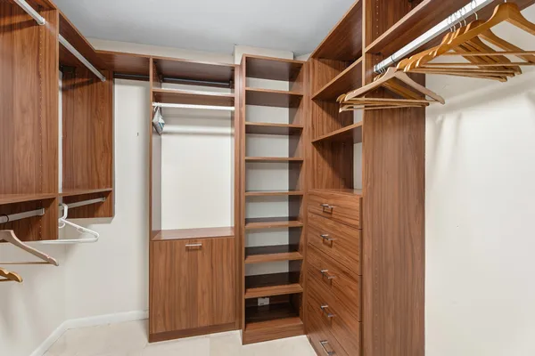 a view of walk in closet with empty racks