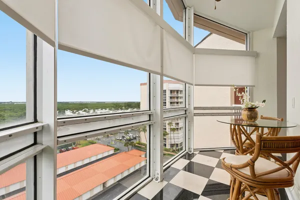 a view of a chairs and table in the balcony