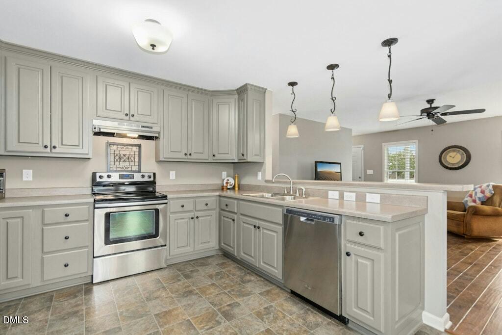 1052 Aquilla Road Benson, NC 27504 - Photo 11 of 31 a kitchen with stainless steel appliances granite countertop a stove and cabinets