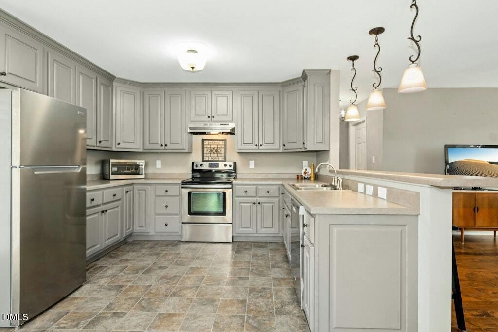 1052 Aquilla Road Benson, NC 27504 - Photo 12 of 31 a kitchen with a sink stove and refrigerator