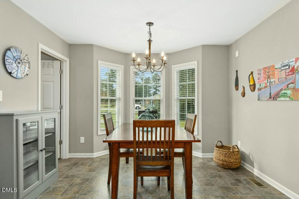 1052 Aquilla Road Benson, NC 27504 - Photo 14 of 31 a view of a livingroom with furniture window and a kitchen