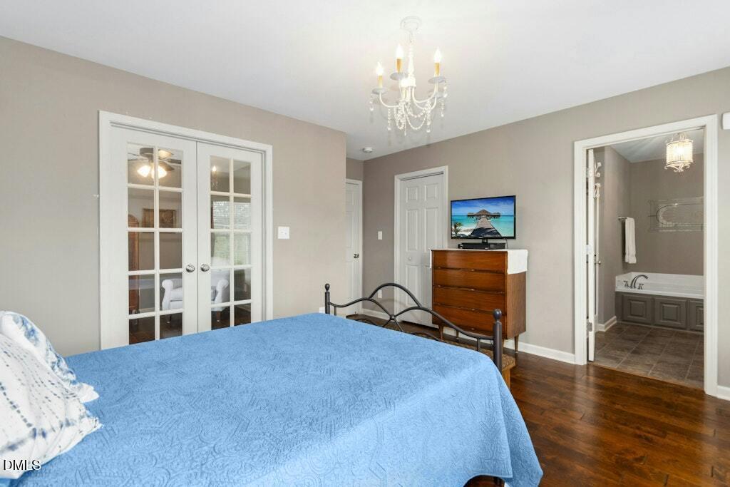1052 Aquilla Road Benson, NC 27504 - Photo 20 of 31 a bedroom with a bed and wooden floor