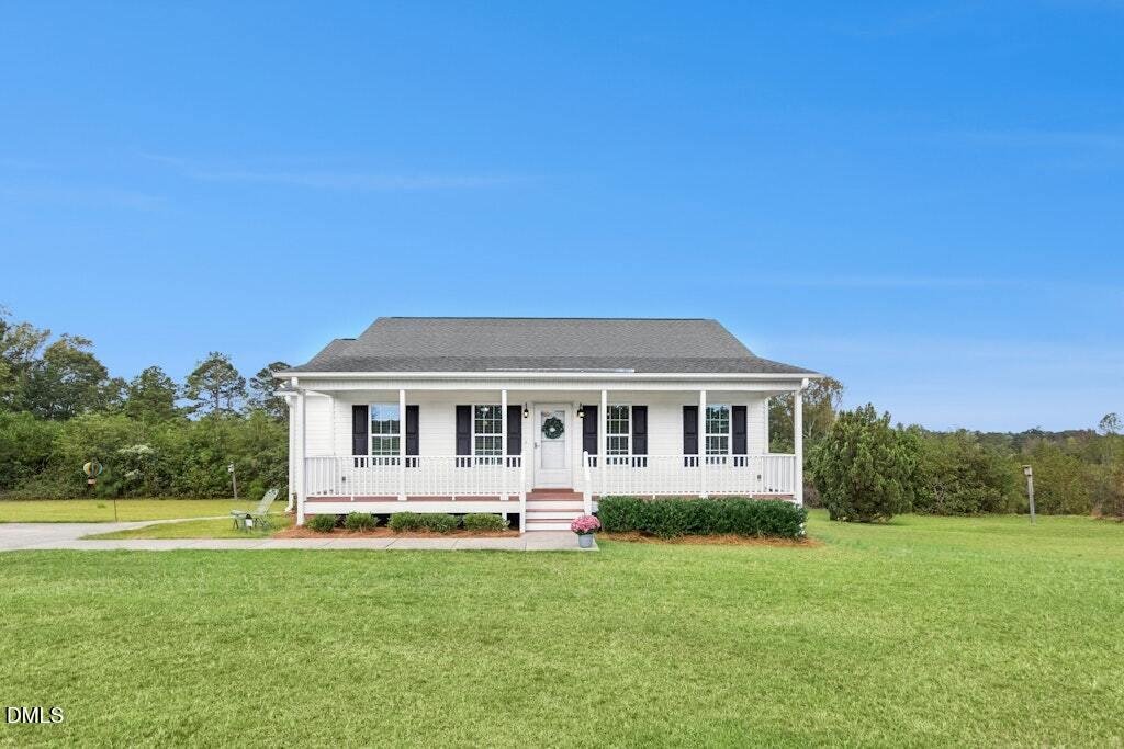 1052 Aquilla Road Benson, NC 27504 - Photo 4 of 31 a front view of a house with yard