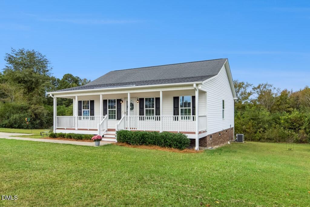 1052 Aquilla Road Benson, NC 27504 - Photo 6 of 31 a front view of house with a garden