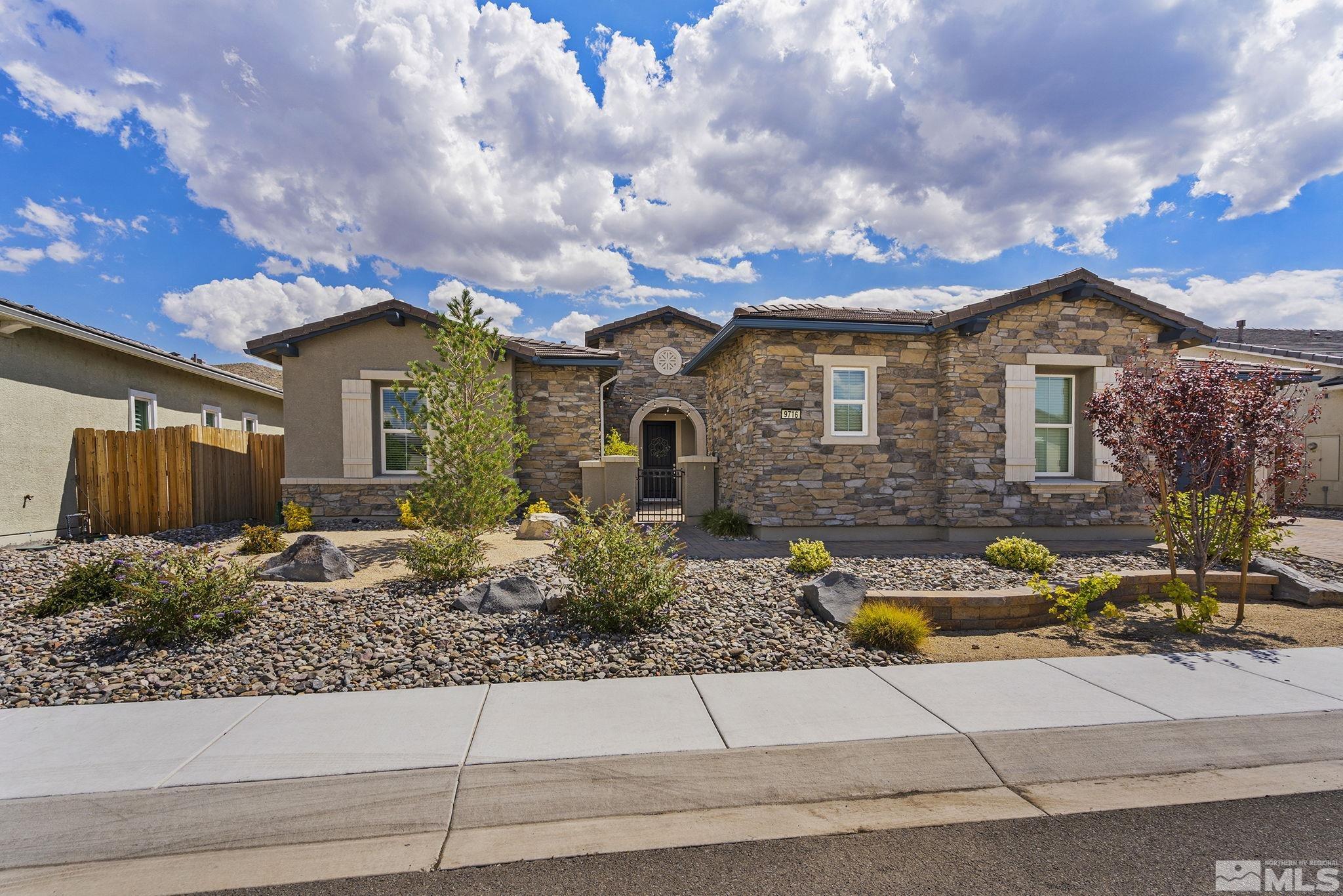 9716 Silverspar Street Reno, NV 89521 - Photo 1 of 40 a front view of a house with garden