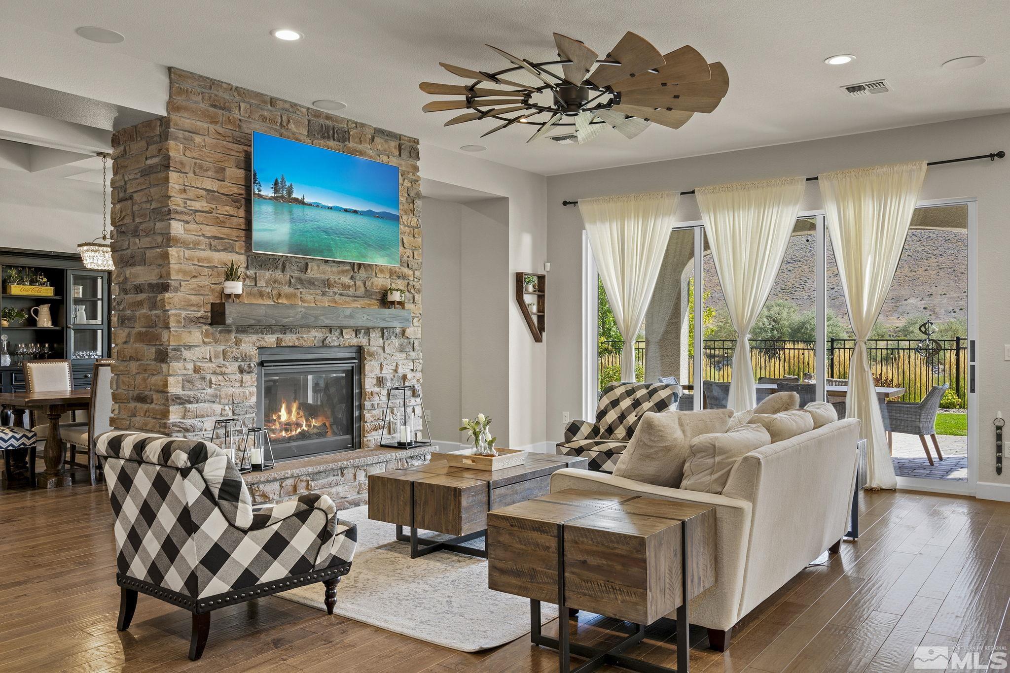 9716 Silverspar Street Reno, NV 89521 - Photo 11 of 40 a living room with furniture fireplace and floor to ceiling windows