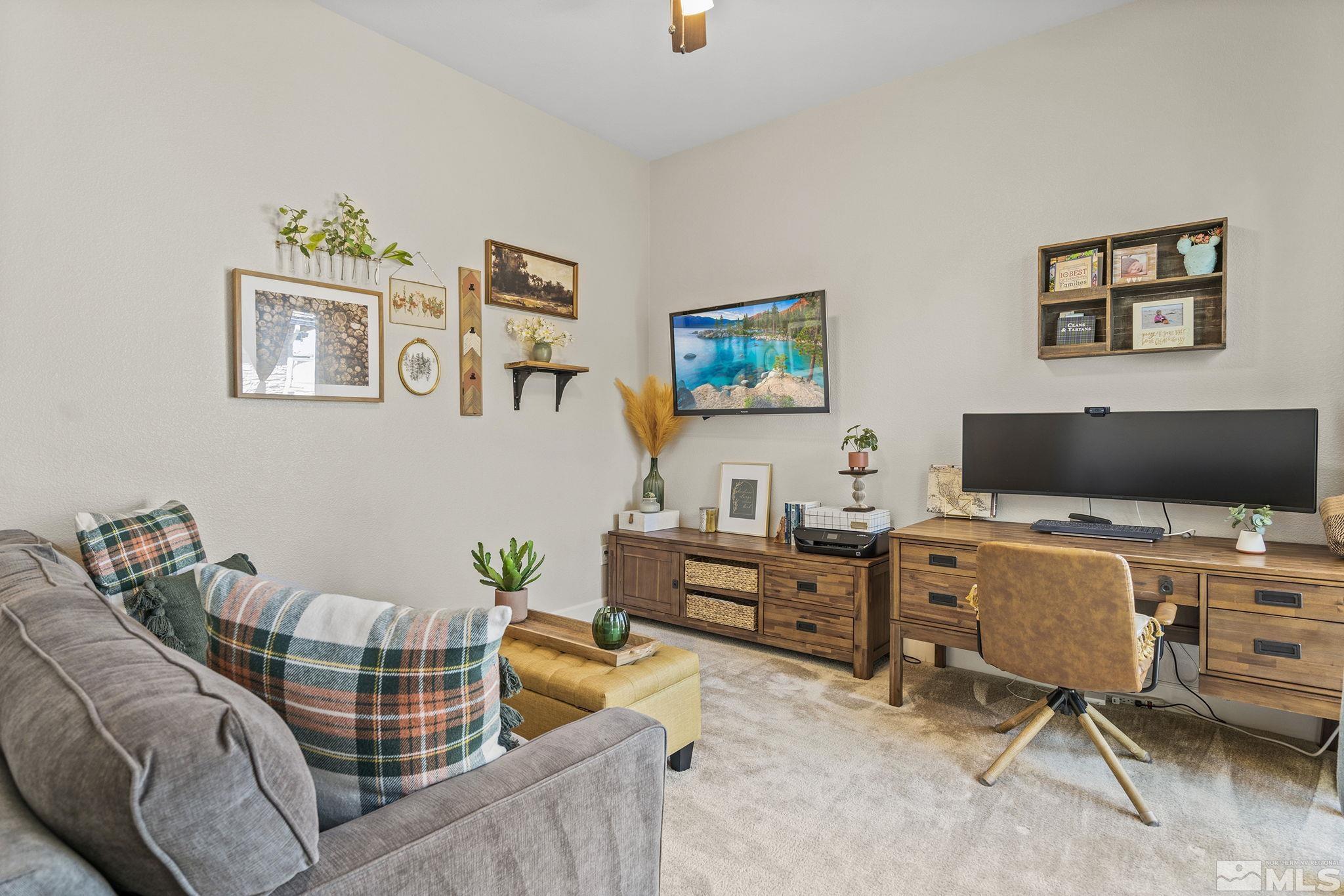 9716 Silverspar Street Reno, NV 89521 - Photo 26 of 40 a living room with furniture and a flat screen tv
