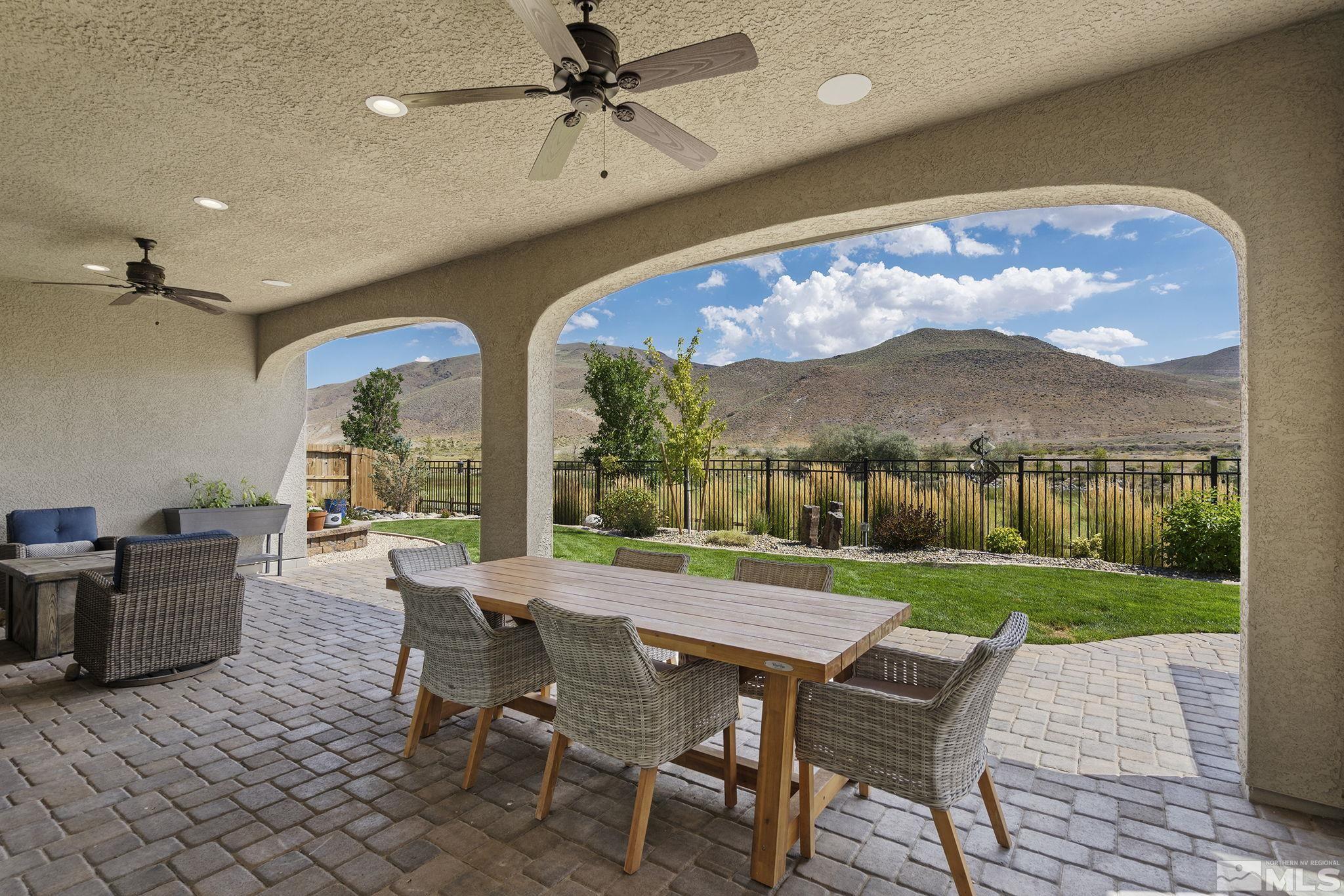 9716 Silverspar Street Reno, NV 89521 - Photo 31 of 40 a view of a patio with a table chairs and a backyard