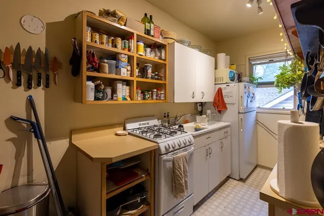 a kitchen that has a table and chairs in it