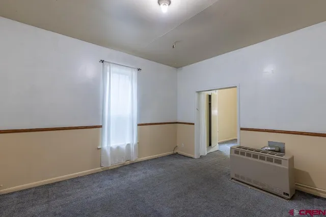 a view of an empty room with windows