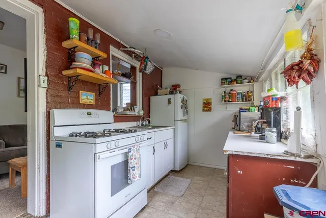 a kitchen with stainless steel appliances granite countertop a stove and a sink