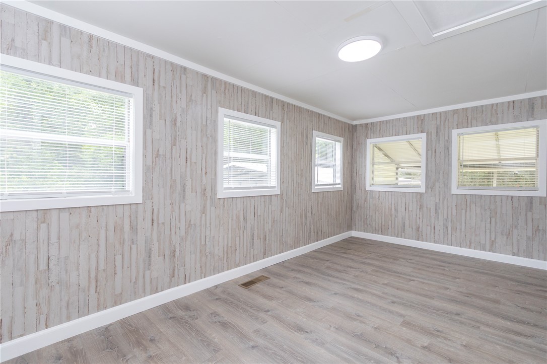 1317 East Broad Street Iva, SC 29655 - Photo 11 of 29 Naturally illuminated, this versatile room features wide windows and durable plank flooring.