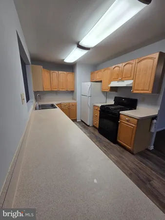 a kitchen with stainless steel appliances a stove and a refrigerator