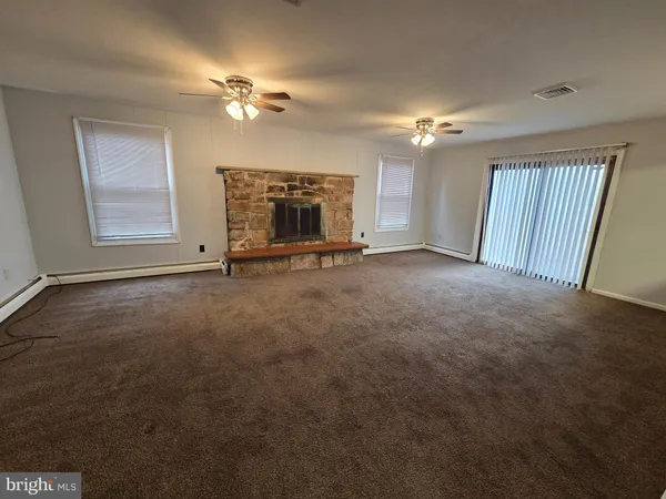 a view of an empty room with a fireplace