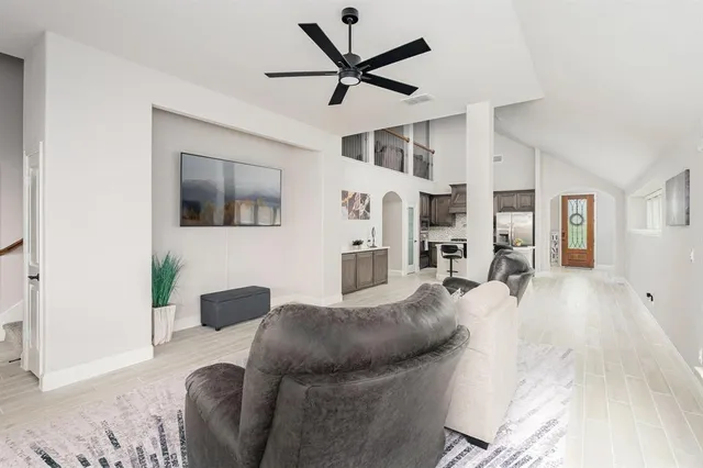 a living room with furniture and a wooden floor