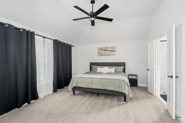 a spacious bedroom with a bed and a window