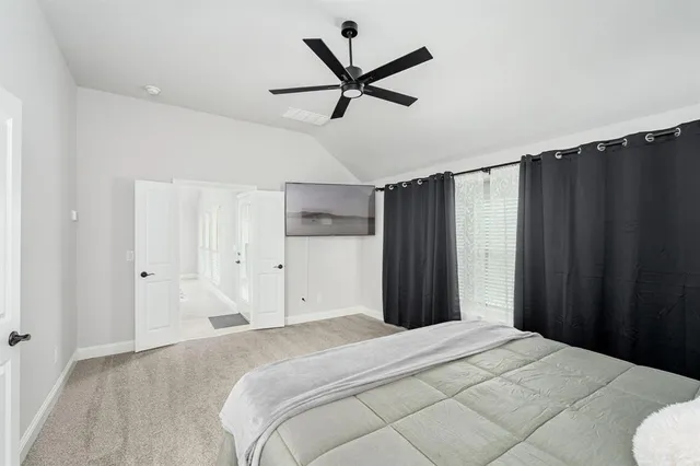 a bedroom with a bed and a ceiling fan