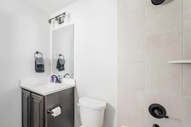 a bathroom with a sink toilet and vanity