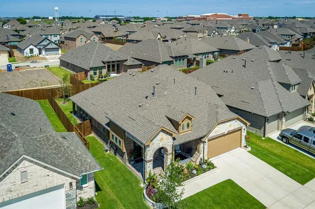 an aerial view of residential houses with outdoor space