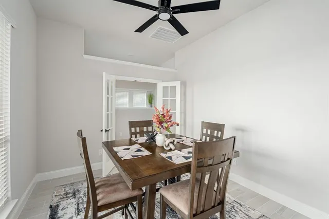 a view of a dining room with furniture and a potted plant