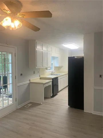 a kitchen with a sink and a refrigerator